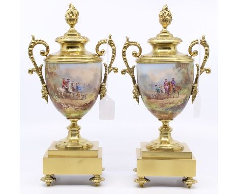 A pair of gilt brass hand painted urn garnitures, with 18th Century scenes