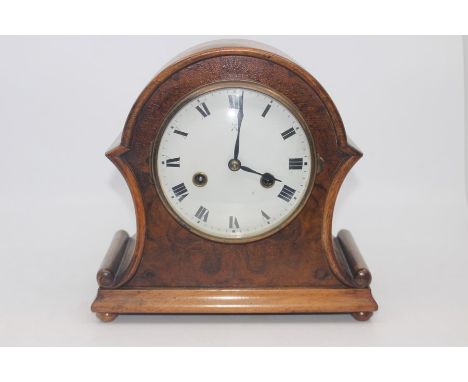 An early 20th Century walnut eight day mantel clock, white enamelled dial and Roman numerals