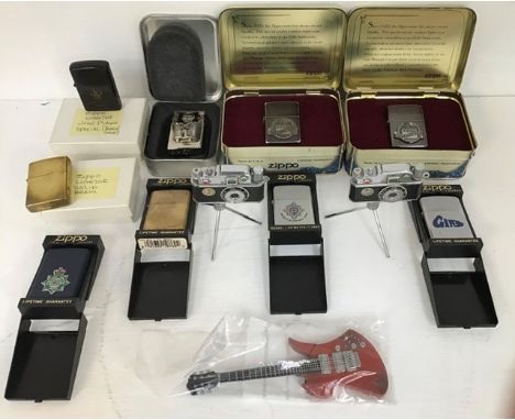 Seven decimal coin packs, a collection of Zippo lighters, two camera lighters and a guitar lighter