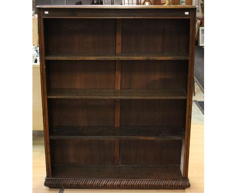 An early 20th Century oak open bookcase, fitted with three fitted shelves and a base shelf, plinth base, 152cm high, 122cm wi