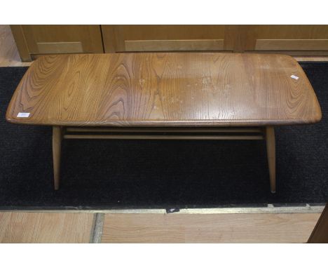 An Ercol ash and beech coffee table, with spindle turned stretcher tier, measuring 37cm high, 104cm wide, 43cm deep