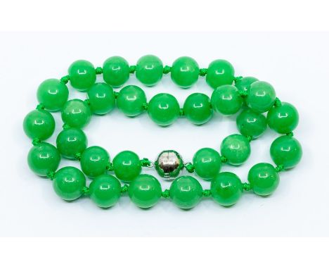 A Burmese jade necklace, beads approx 15mm-17mm, with a magnetic rhodium plated sterling silver clasp, total carat weight app