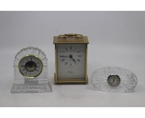 Three various clocks, comprising a Waterford cut glass mantle clock, a further cut glass mantle clock, and a quartz movement 