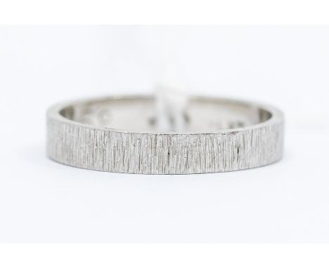A platinum wedding band, engraved bark detail, size R, total gross weight approx 5.3gms Condition report: God- minor wear and