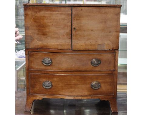 An early to mid 19th Century mahogany pot cupboard, comprising two doors over two drawers, raised on bracket feet, 71cm high,