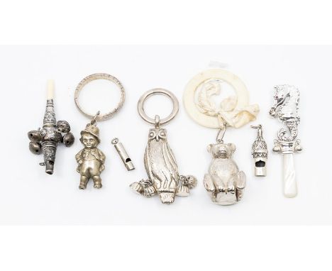 A collection of early 20th Century silver & white metal baby rattles to include: Traditional with four bells and a whistle en