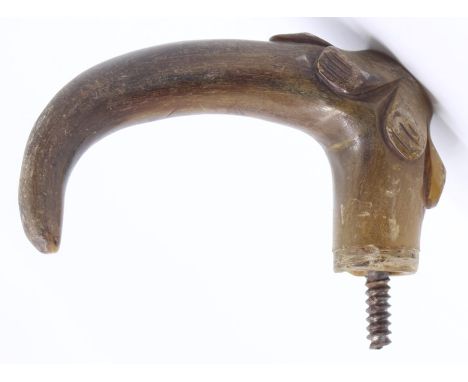 A rhino horn walking stick handle, 11cm long, with floral detail