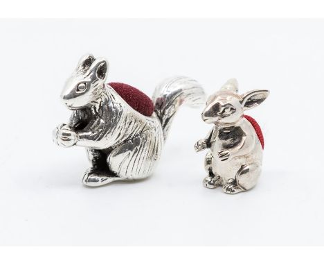 A modern Sterling silver squirrel pin cushion, stamped to the base together with a small seated rabbit pin cushion, maker's m