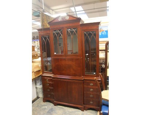 A Chippendale style mahogany display cabinet, the upper section with a broken shaped pediment, comprising four glazed doors, 