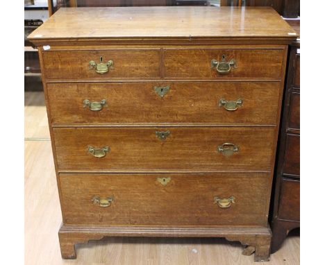 A George III oak chest of drawers, comprising two short over three long graduated drawers, all drawers fitted with original l