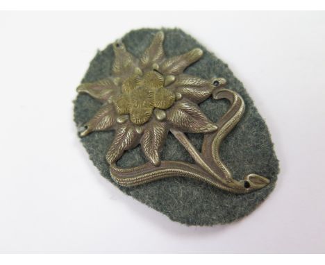 German Alpine Troops (Gebirgsjaeger) officers two piece bi-metal Edelweiss cap badge, variety with peripheral holes for attac