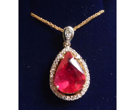 An 18ct. Yellow Gold Ruby and Diamond Pendant set with large pear shaped ruby surrounded by diamonds and with 18ct. yellow go