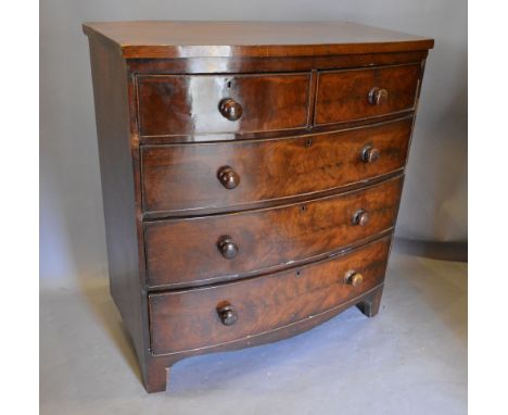 A Victorian Mahogany Bow Fronted Chest of two short and three long drawers with knob handles raised upon bracket feet, 101 cm