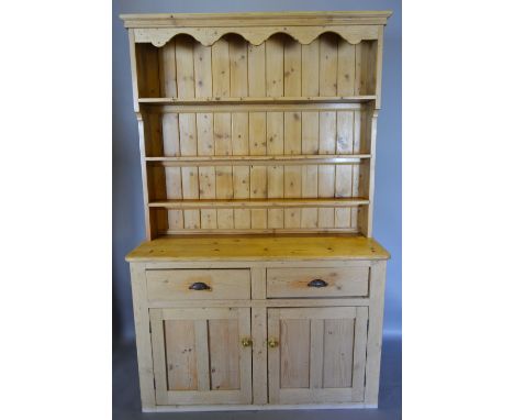 A Late 19th Century Pine Dresser, the boarded shelf back above a lower section with two drawers above two cupboard doors, 137