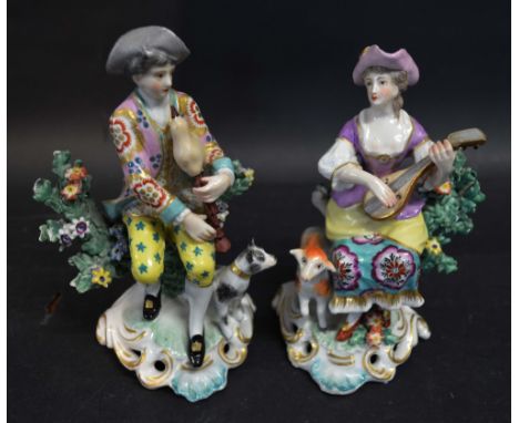 A Pair of Continental Figurines 'Man and Lady Playing Musical Instruments with Animals at their Feet' 14 cms tall