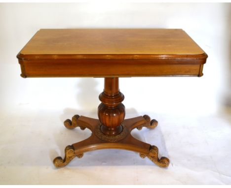 A French Mahogany Card Table, the hinged top enclosing a baize lined interior above a baluster centre column in quadripartite