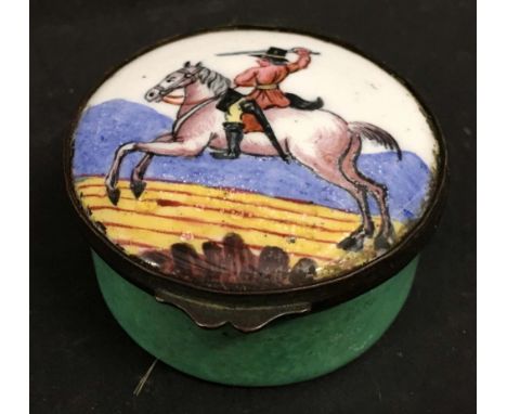 A 19th Century Enamel Decorated Box of Circular Form, decorated in polychrome enamels with a horse rider, 6 cms diameter