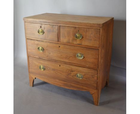 A 19th Century Elm Chest of two short and two long drawers with oval brass handles raised upon bracket feet, 92 cms wide