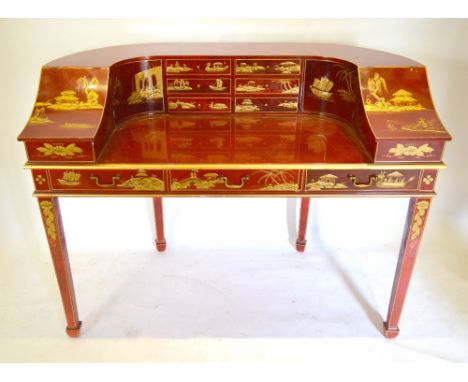 A Red Lacquered Chinoiserie Decorated Carlton House Desk with an arrangement of drawers and compartments all raised upon squa