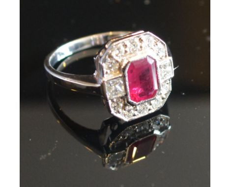 An 18ct. White Gold Ruby and Diamond Ring, with a rectangular ruby surrounded by diamonds within a pierced setting, approx. 0