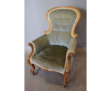 A Victorian Drawing Room Armchair with a button upholstered back above a stuff over seat and with scroll arms raised upon cab