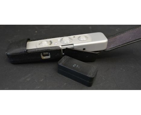 A Minox Miniature Spy Camera with flash and original case and bakelite container containing film