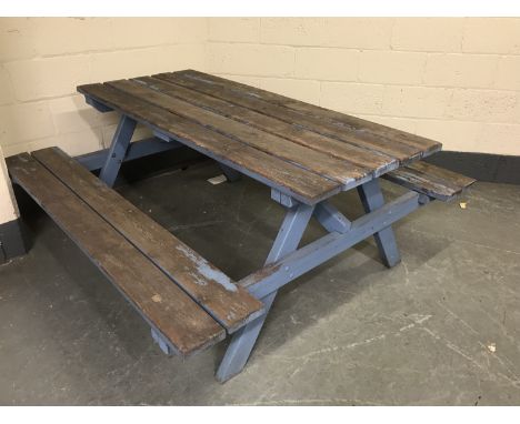 A fixed position wooden table and bench set, width 180cm