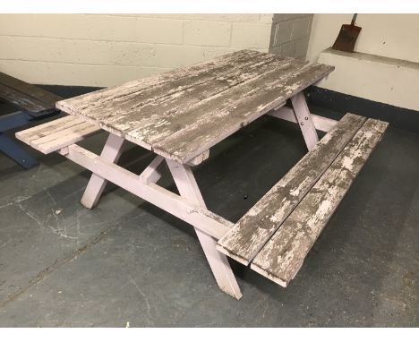 A fixed position wooden table and bench set, width 180cm