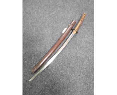 A WWII Japanese NCO's katana, with 69cm blade, iron tsuba with brass inlay, braid-bound grip with twin chrysanthemum menuki, 