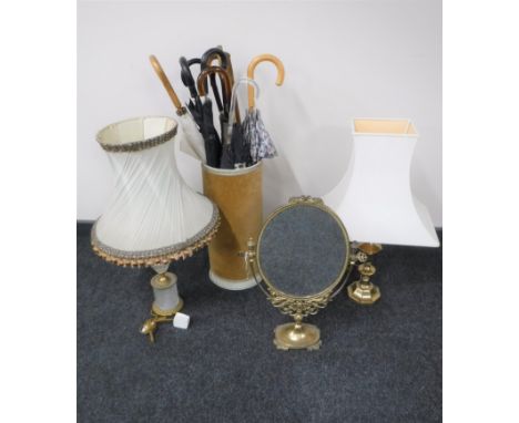 A brass dressing table mirror together with a brass table lamp and one other and a stick stand containing assorted umbrellas 