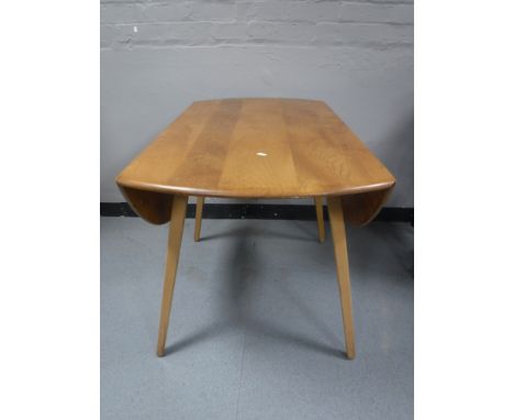 An Ercol elm drop leaf table