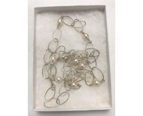 A sterling silver and pearl long linked necklace