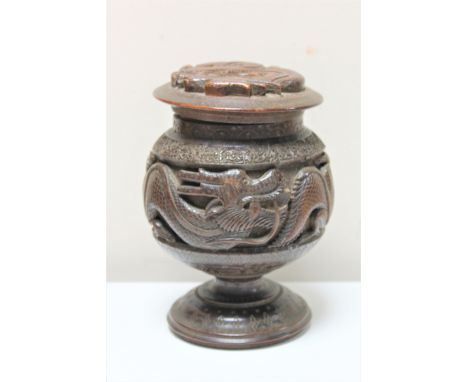 An oriental carved hardwood lidded spice jar