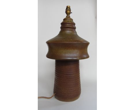 A Studio pottery table lamp with brown oatmeal glazed. Impressed potters mark, firing crack from base 