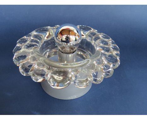 A glass wall light with metal base