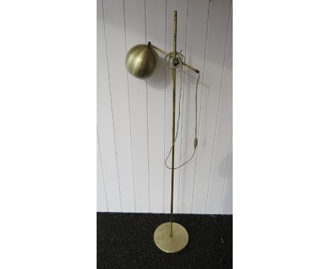 A brassed standard lamp with large globe spot 