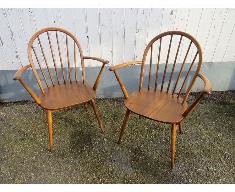 A pair of Ercol light elm carver chairs 