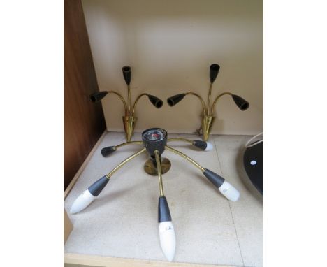A 1950's ceiling light in black and gilt with six branches together with two matching three branch wall lights 