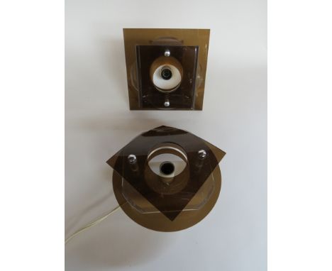 Three square form clear and smoked amber perspex wall lights together with a circular matching light