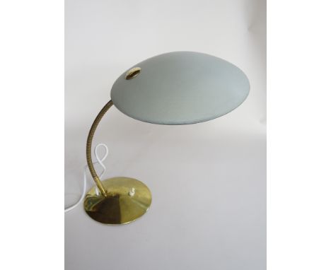 A flexible hooded metal lamp on a brass base 