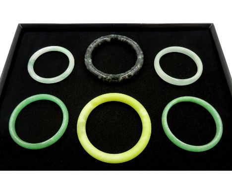Four green jade bangles and two other bangles - Condition Report 