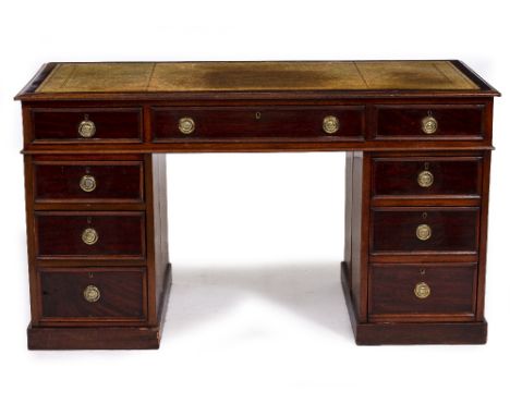 A LATE 19TH / EARLY 20TH CENTURY MAHOGANY PEDESTAL DESK with a leather inset top, nine drawers with brass ring handles, 137.5