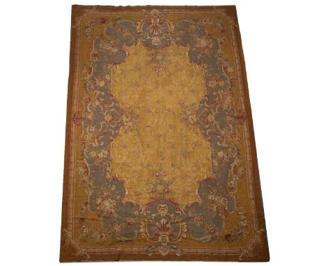 AN 18TH CENTURY FRENCH STYLE GOLD GROUND NEEDLEWORK SMALL CARPET with flowers to the central field within a scrolling floral 