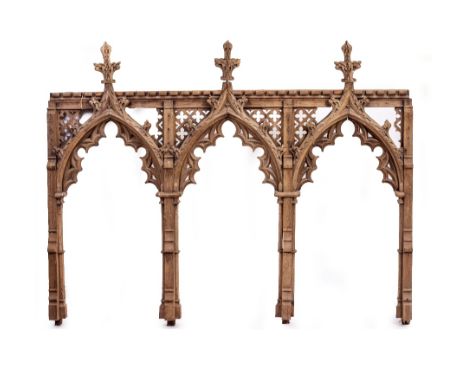A 19TH CENTURY OAK GOTHIC REVIVAL REREDOS OR ROOD SCREEN in three sections, with pierced fretwork decoration, 214cm wide over
