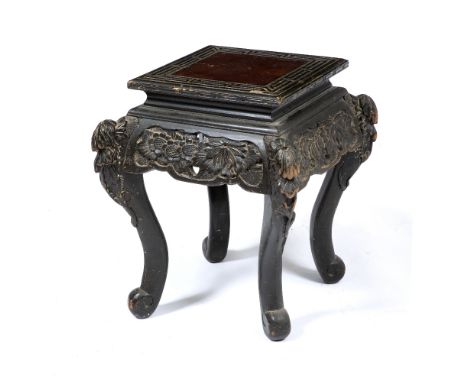 A CHINESE CARVED EBONISED WOOD URN STAND  of square section, standing on shaped legs and terminating in scroll feet, 40cm wid