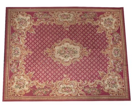 AN 18TH CENTURY FRENCH STYLE NEEDLEWORK BURGUNDY GROUND SMALL CARPET with central cartouche within a geometric flowerhead dec