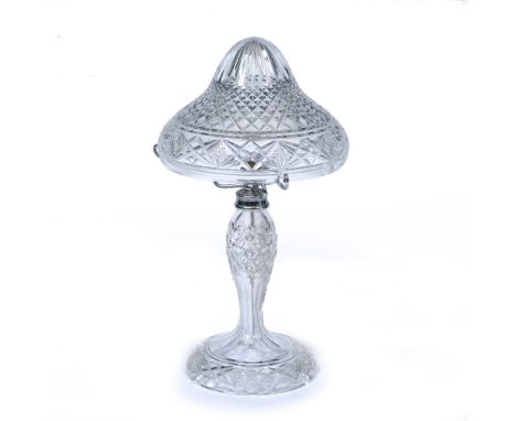 A TABLE LAMP  with cut glass shade and body and on a spreading circular base, 26cm diameter x 49cm high At present, there is 