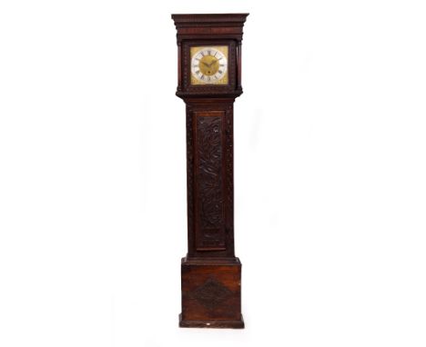 AN EIGHT DAY LONG CASE CLOCK  the oak case with later chip carved decoration, the brass dial with decorative spandrels and ri