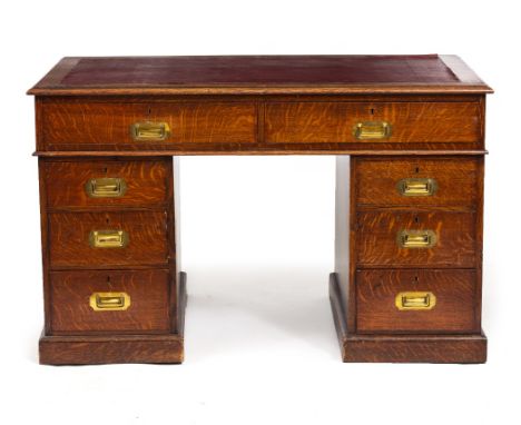 A MID 20TH CENTURY OAK PEDESTAL DESK  with leatherette inset top and inset brass handles to the oak lined drawers, top drawer