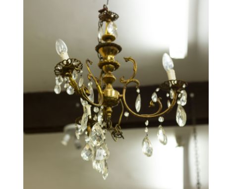 A MID 20TH CENTURY BRASS THREE BRANCH ELECTROLIER OR CHANDELIER  with cut glass drops Condition: some oxidisation to the meta